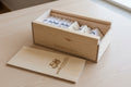 Wooden box with cards and a wooden card holder on a textured surface